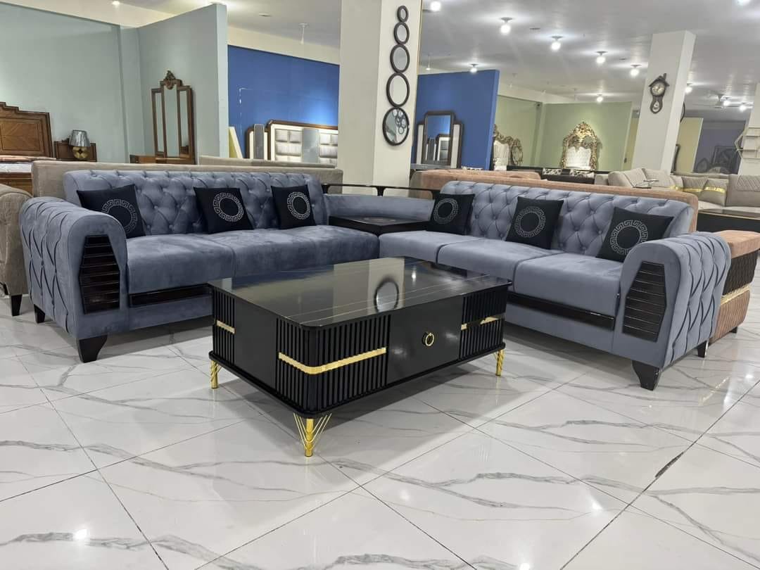 Grey sectional sofa and a black coffee table in the Ideas Furniture showroom